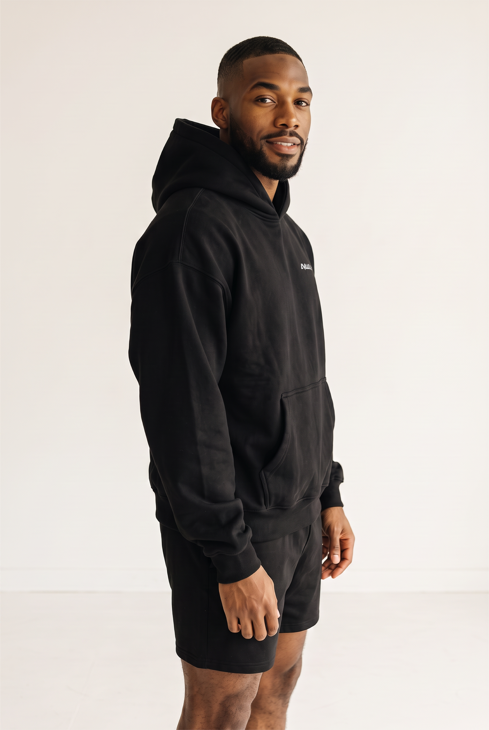 NWLY black oversized performance hoodie, angled side view