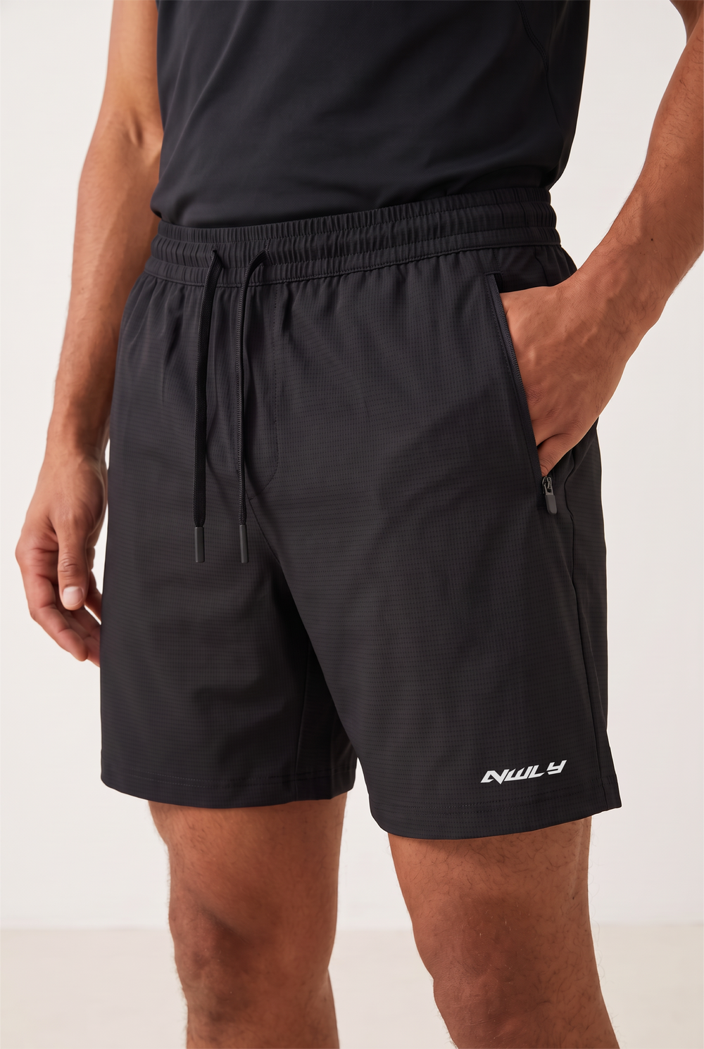 NWLY black performance training shorts, zipped pocket detail